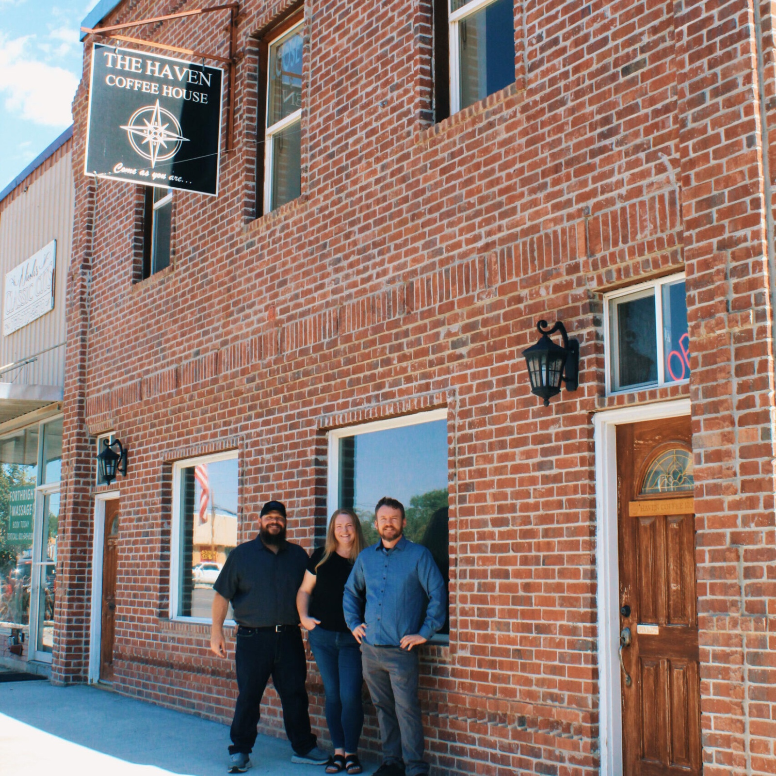 Haven co-owners Tony Perides, Meadow Perides, and James Jenkins standing outside The Haven Coffee House in Nephi